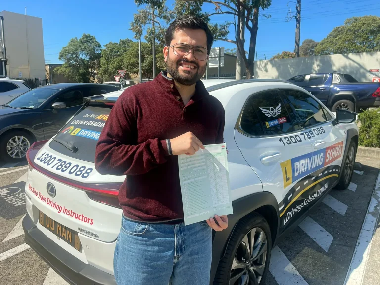 Mandeep with the driving test result beside the L Driving School Lexus after passing at Silverwater